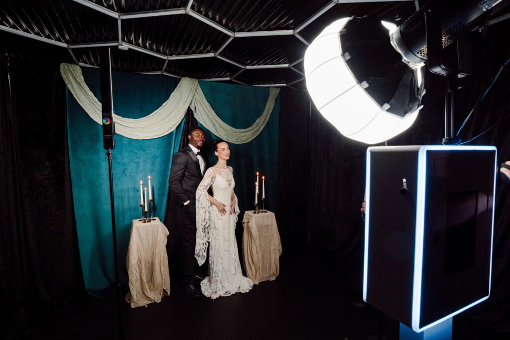 Couple taking a photo in front of photo booth