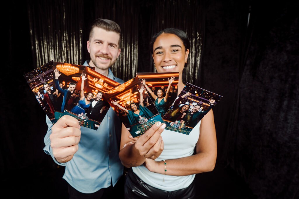 Man and woman holding AI generated images of themselves from a photo booth