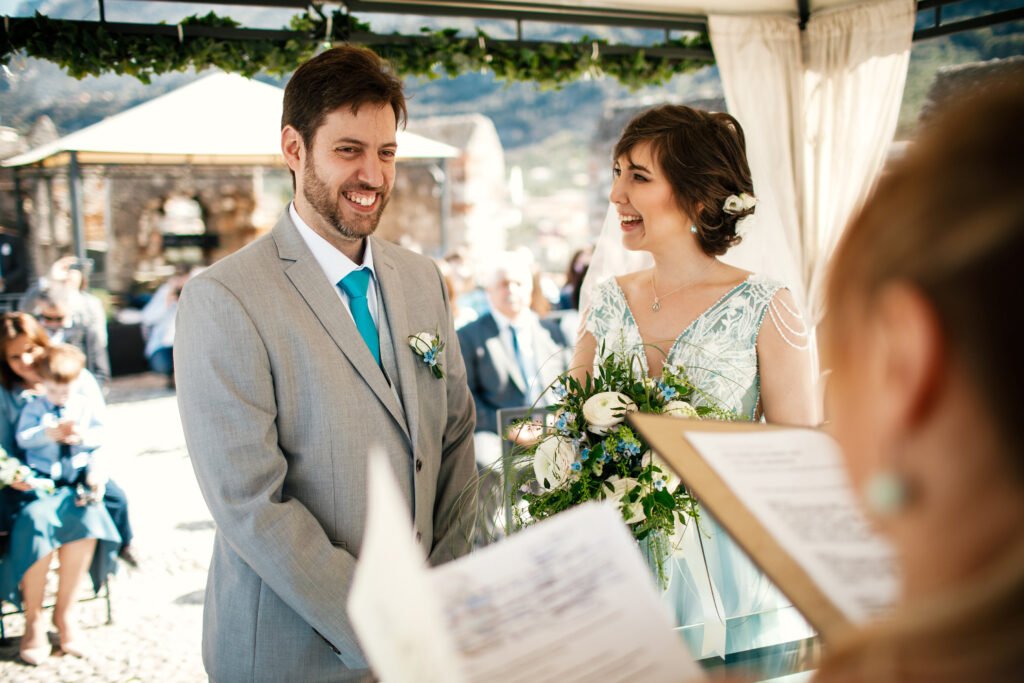 charming newlyweds smile standing before wedding altar