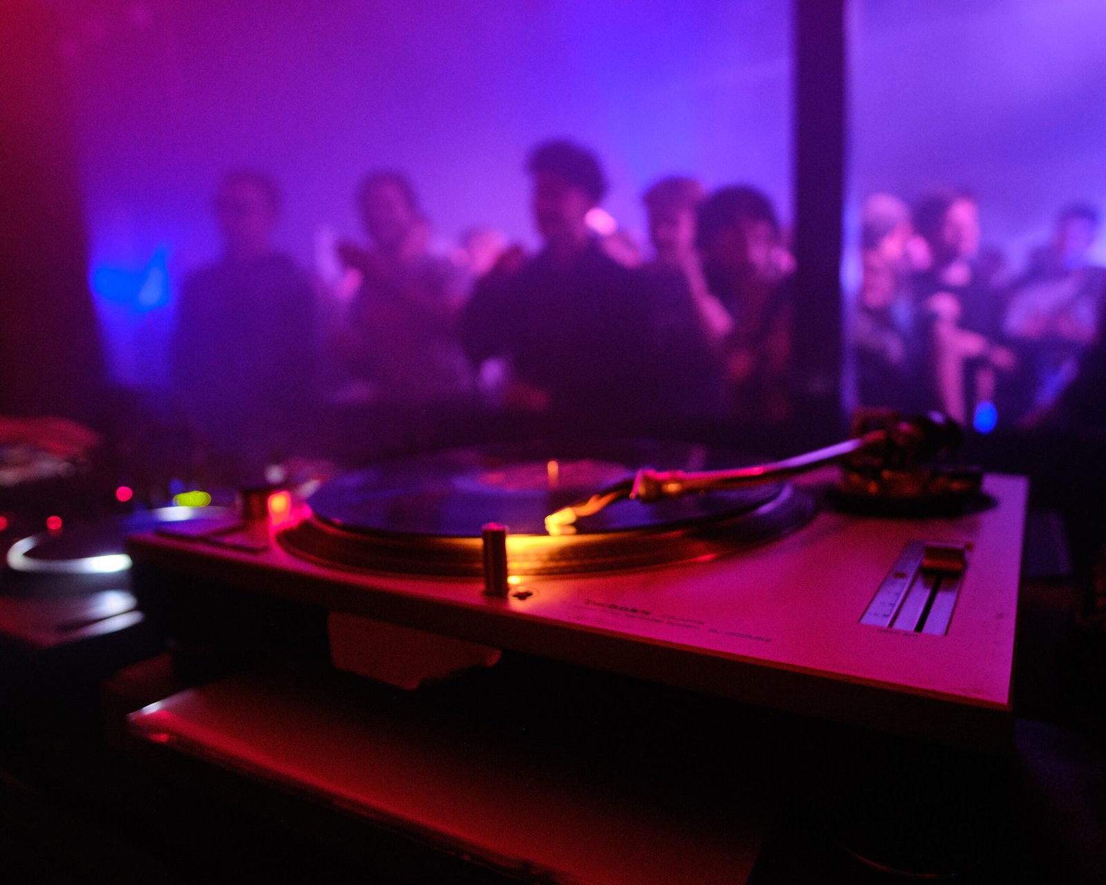 closeup shot dj s equipment people dancing club (1)