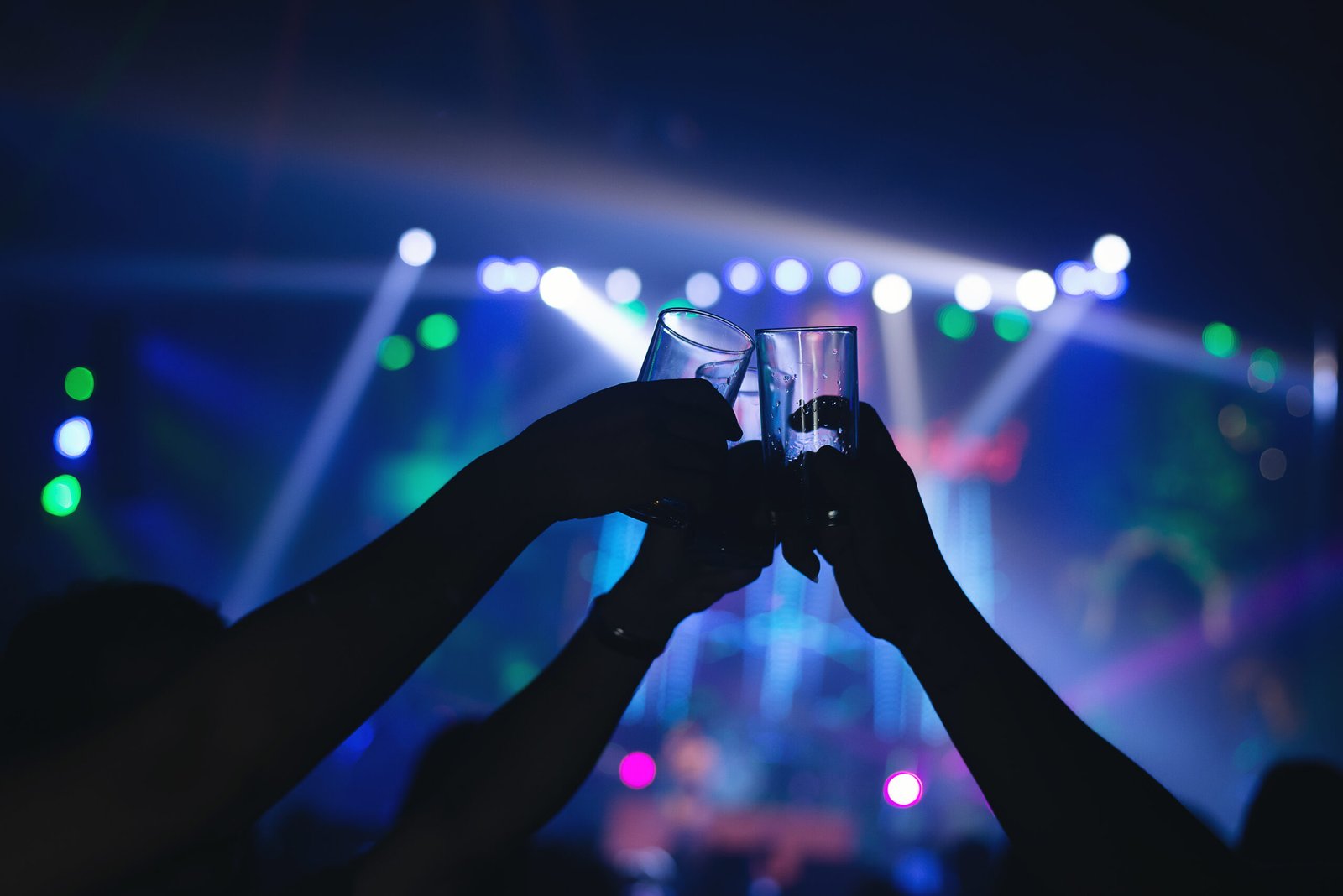 friends clinking drink glasses modern bar