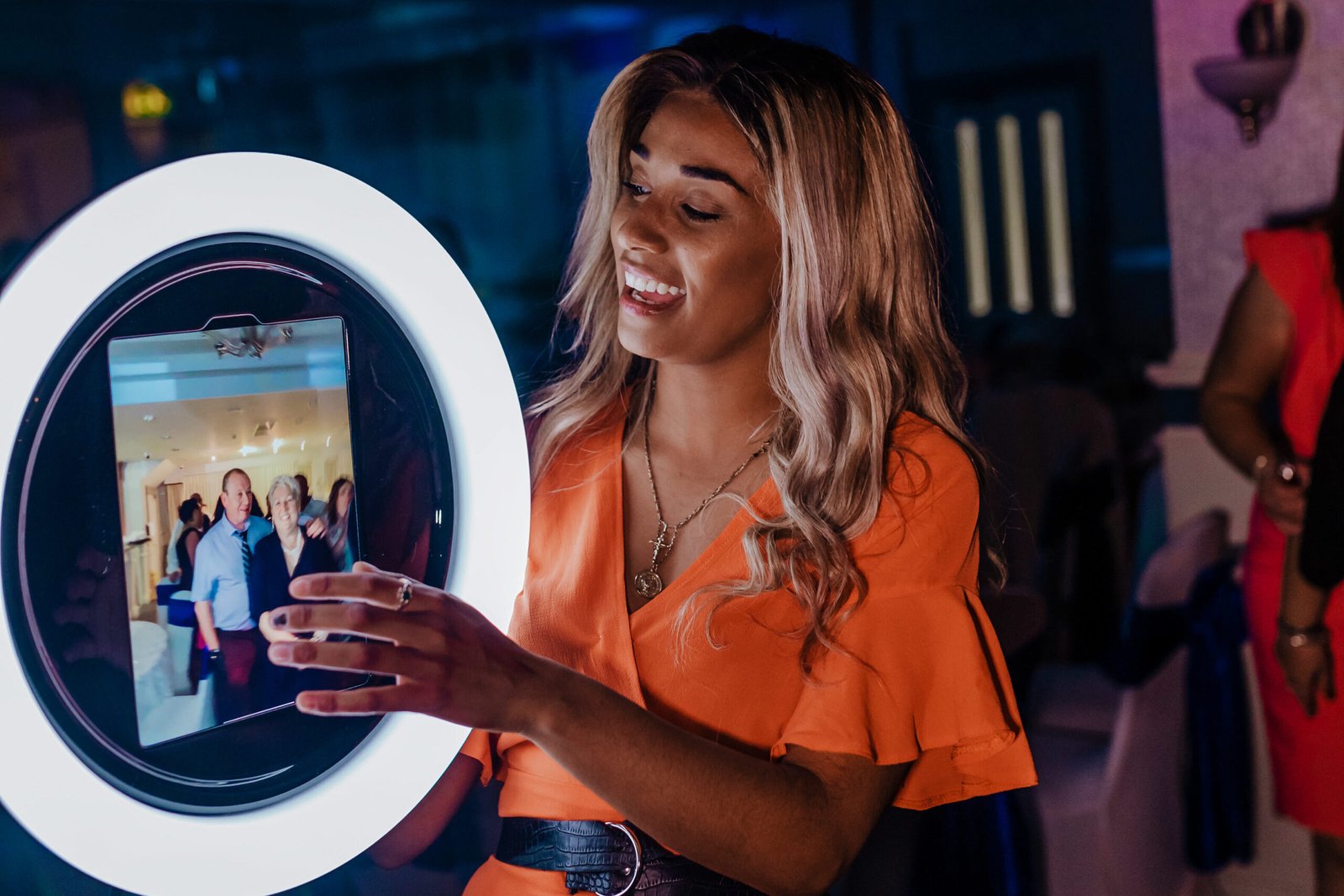 Woman interacting with a photo booth screen